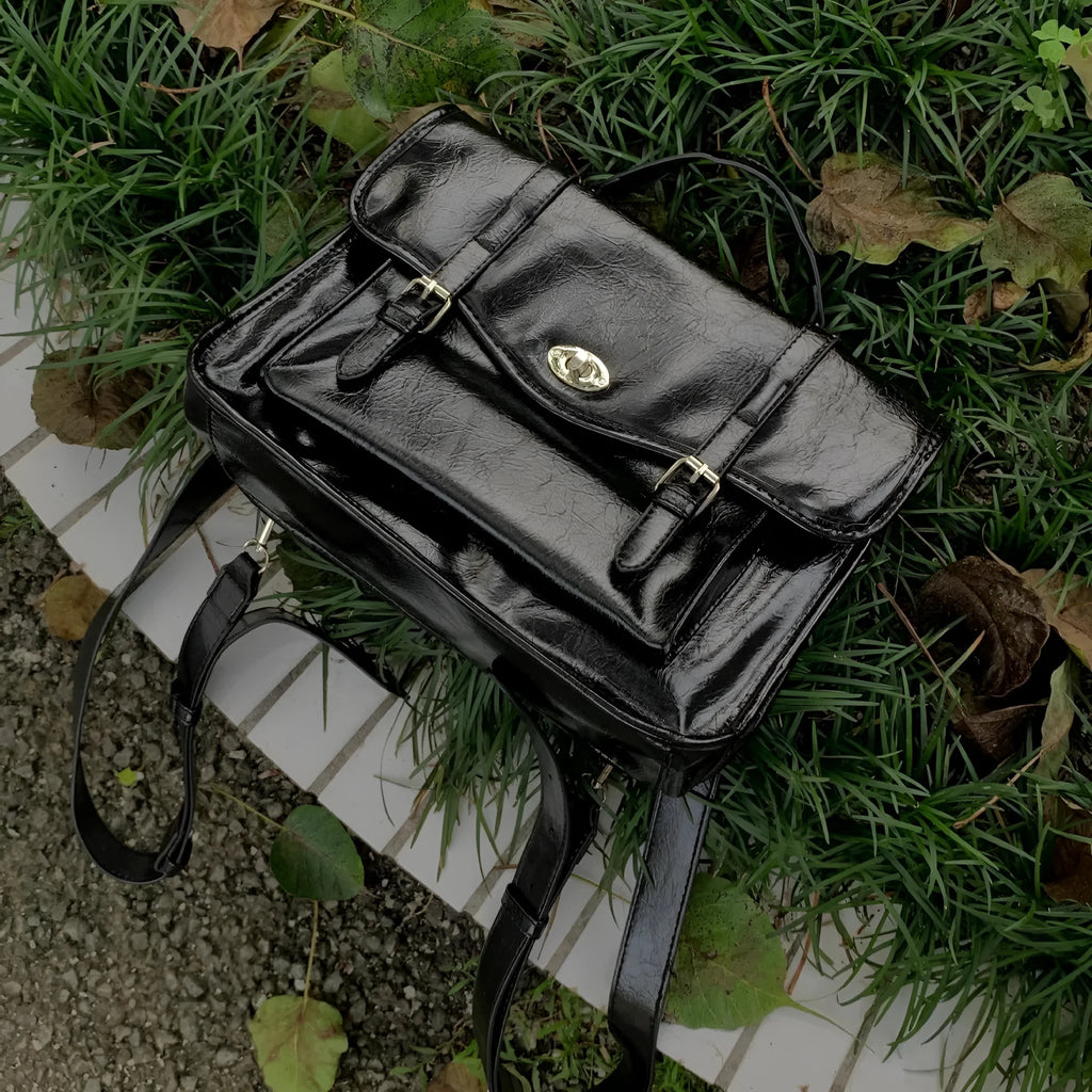 Black college style messenger bag with oil wax leather-look PU material