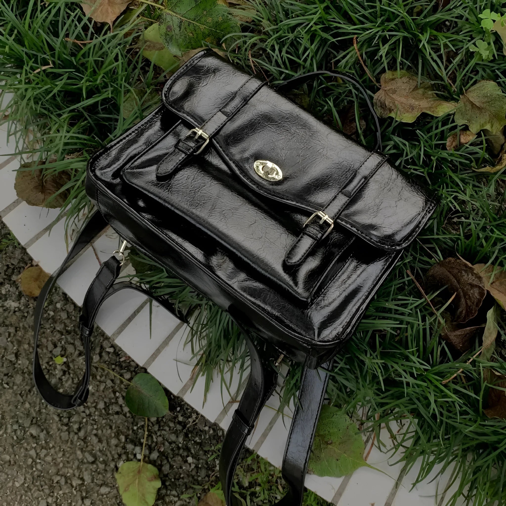 Black college style messenger bag with oil wax leather-look PU material