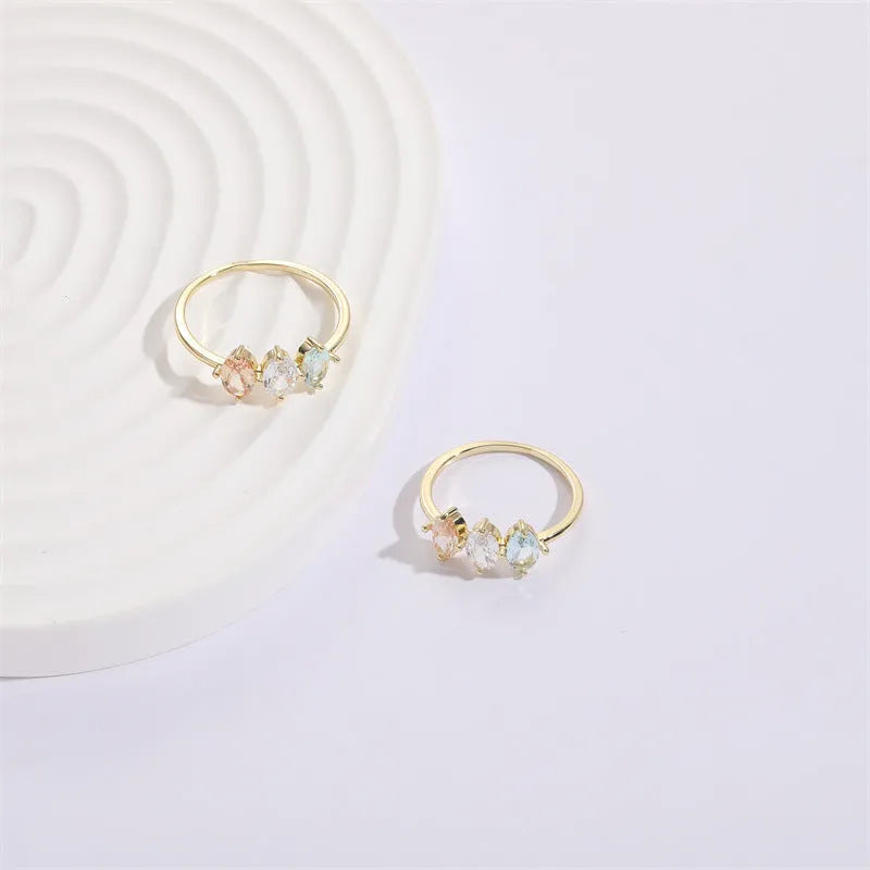 Gold electroplated geometric women's ring with triangular elements and horse eye tricolor zircon birthstone