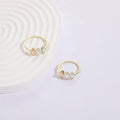 Gold electroplated geometric women's ring with triangular elements and horse eye tricolor zircon birthstone