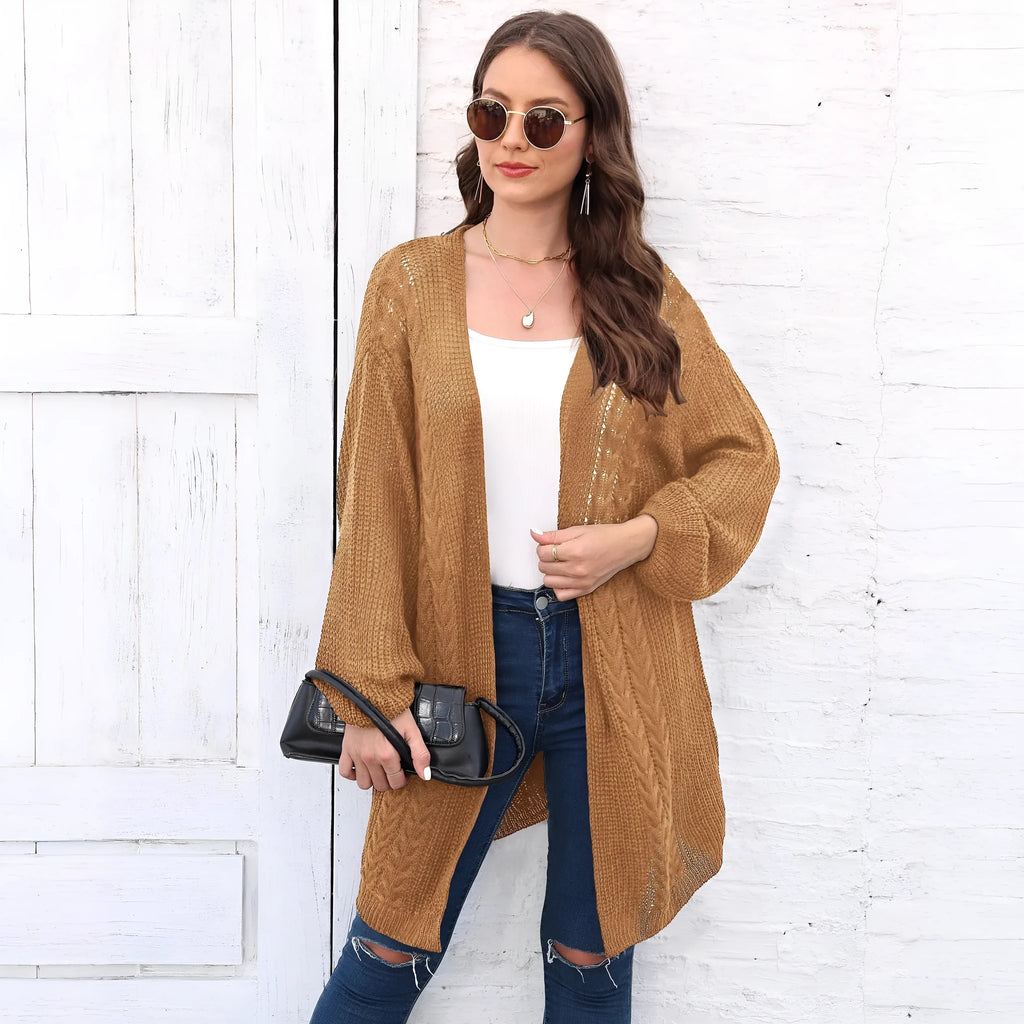 Women's loose brown acrylic sweater coat hanging on a hanger