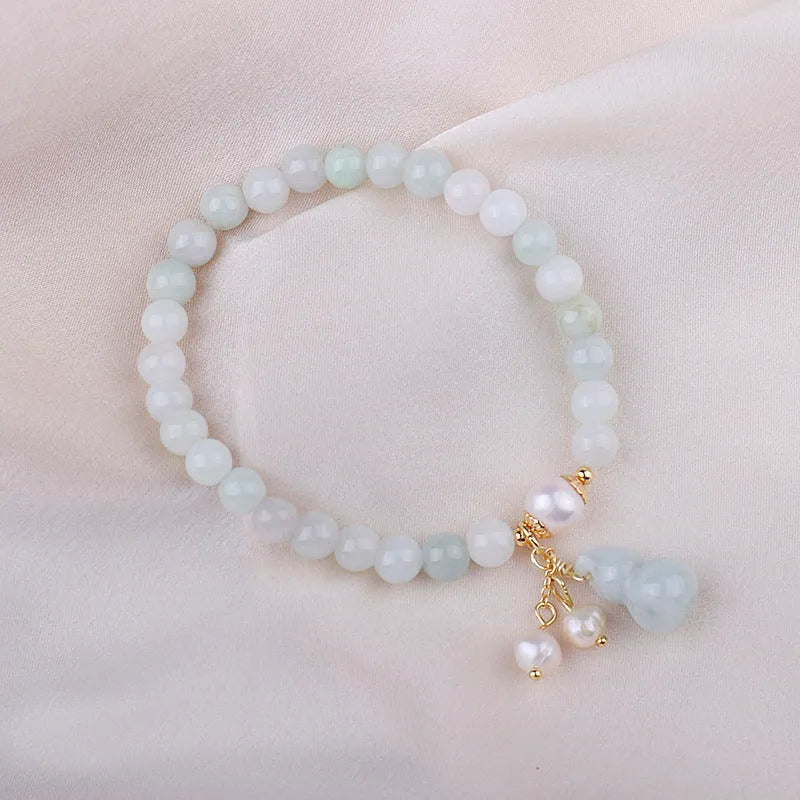Chinese style jade bracelet with gourd design on woman's wrist