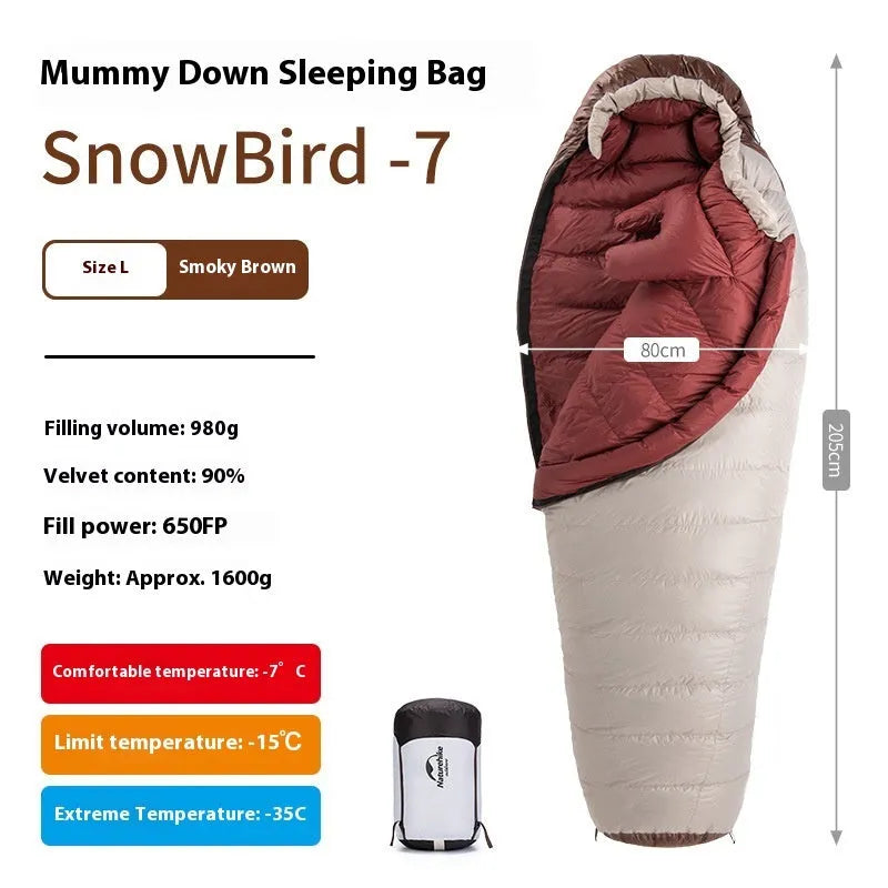 Adult mummy-style sleeping bag with goose down insulation shown with its storage bag.