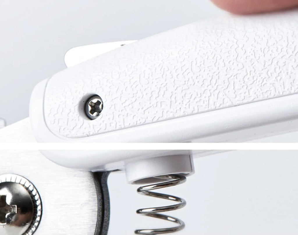 White pet nail clippers with LED light, anti-splash guard, and built-in file on a grey surface