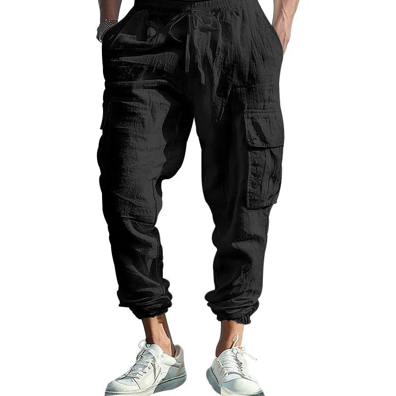 Men's loose-fit linen trousers with ankle-tied cuffs and multiple pockets.
