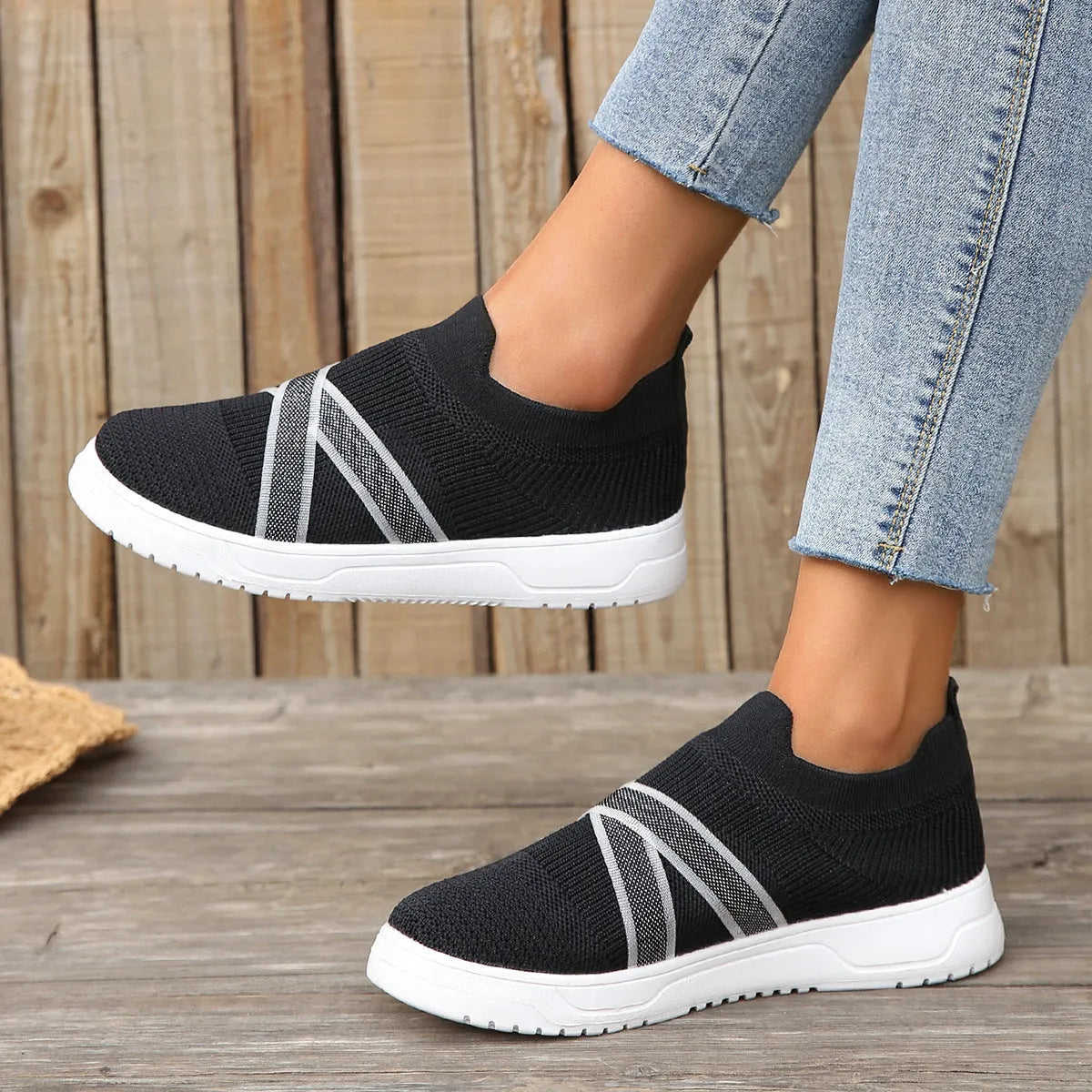 Black women's flat knit mesh shoes with tassel detail and rubber sole