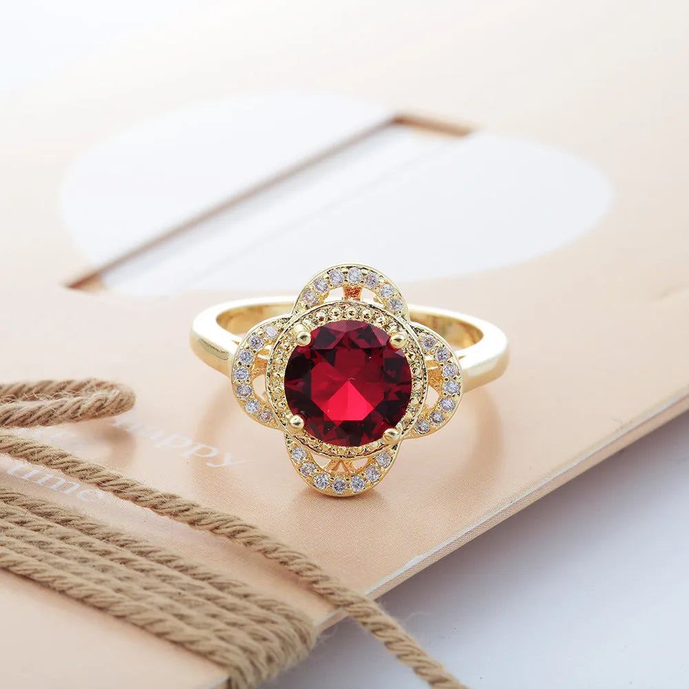 Copper fruit-shaped ring with electroplated zircon detailing on a hand.