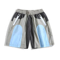 Blue men's patchwork loose-fit quick-drying shorts laid flat, showing straight-leg cut and tether fly.