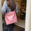 Pink or brown corduroy one-shoulder commuter bag showing dimensions.