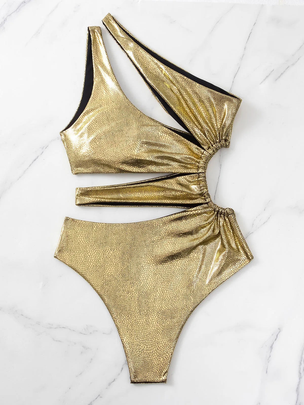 Gold women's one-piece swimsuit with backless and sleeveless design on a mannequin.