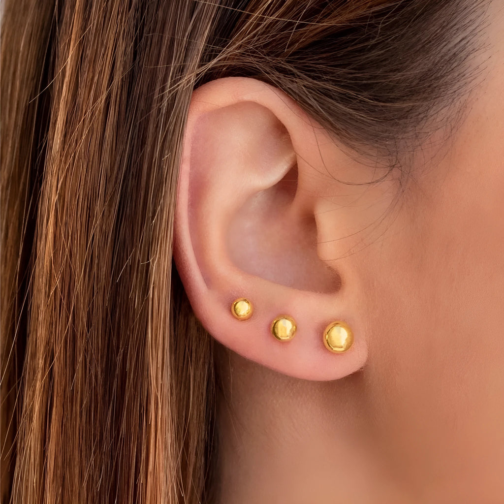 Stainless steel ball stud earrings showing 3mm, 4mm, 5mm, and 6mm sizes with gold and silver finishes