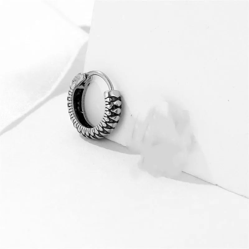 Silver geometric stainless steel earrings with a twist and striped design on a white background.