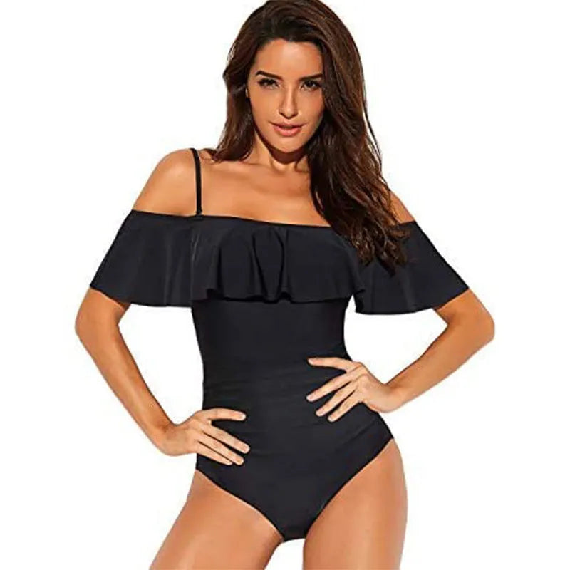 Black women's strapless one-piece swimsuit with a cut-out detail and ruffled strap.