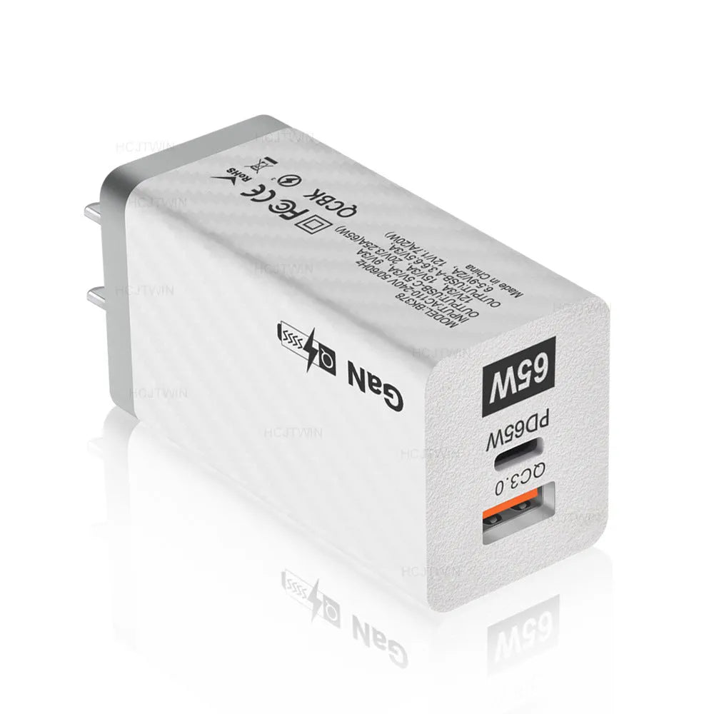 White Gallium Nitride 65W laptop charger with EU UK US plugs showing compact size