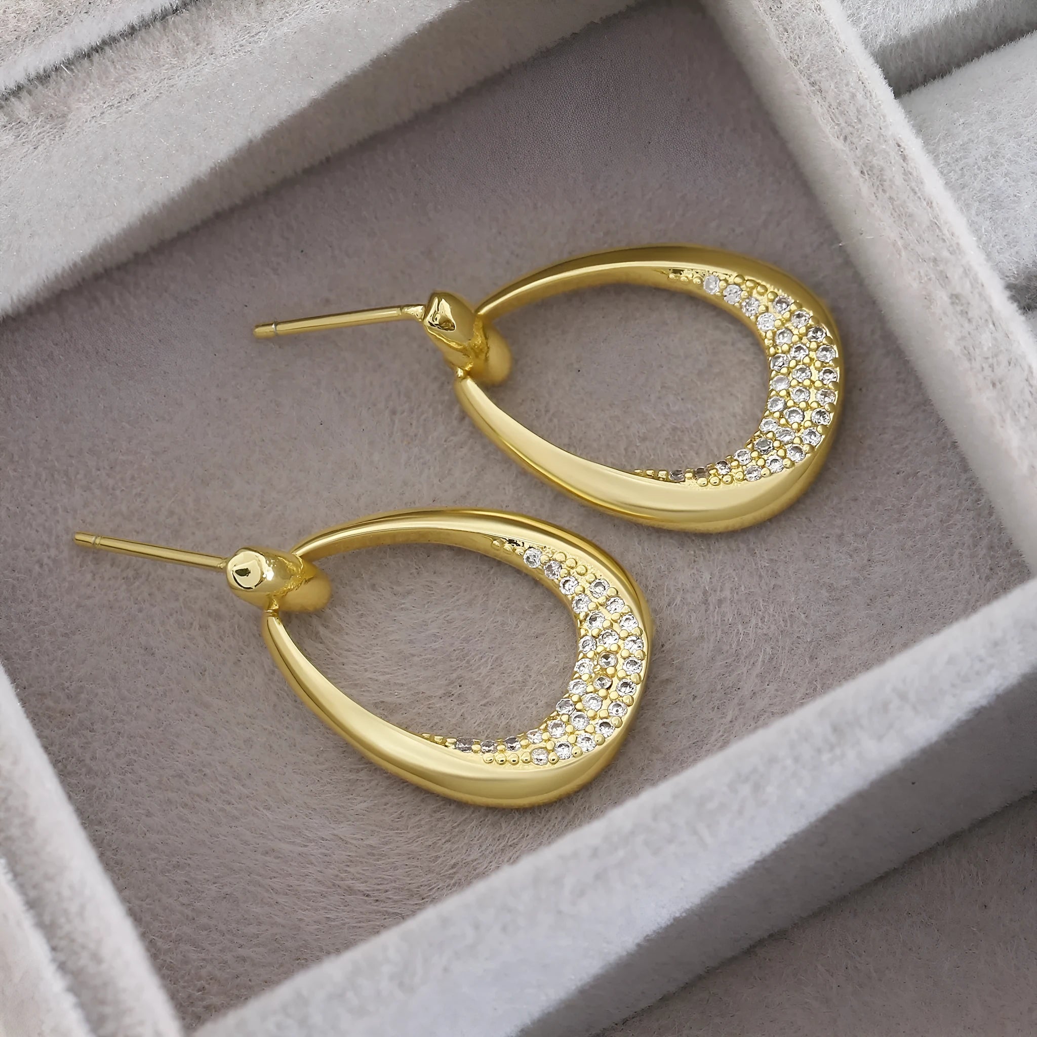 Yellow gold geometric drop earrings with round and oval elements measuring 2.6cm by 1.7cm