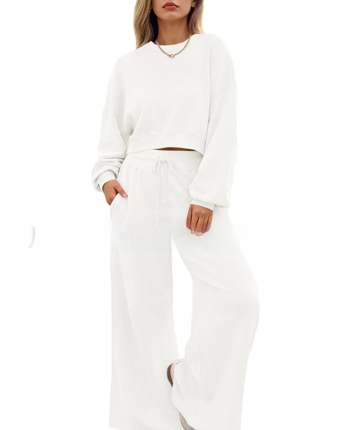 Women's solid colour long sleeve top and trousers two-piece set in polyester fabric.