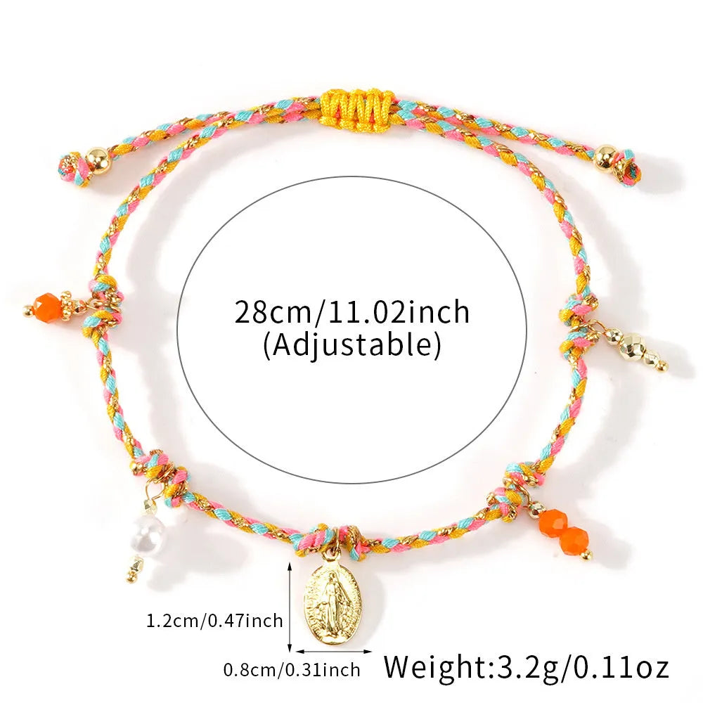 Close-up of a hand-woven colourful braided rope bracelet with a leather closure and strap tag detail.