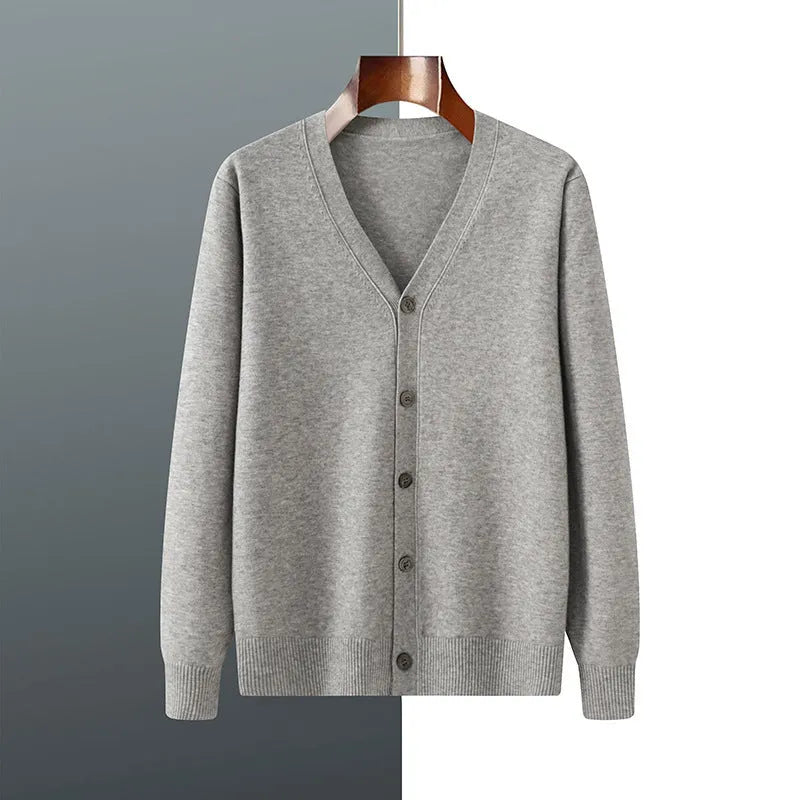 Man wearing a beige V-neck Andy velvet cardigan coat with a loose fit and long sleeves.