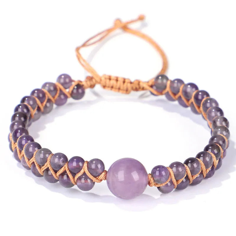 Handwoven geometric pull bracelet made from blue Tigereye stone on a wrist.