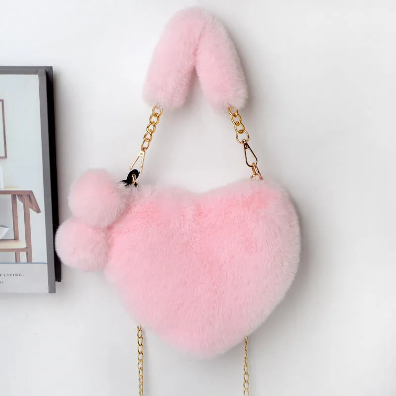 A soft plush heart-shaped women's handbag with a zipper and a detachable shoulder strap in a choice of 14 colours.