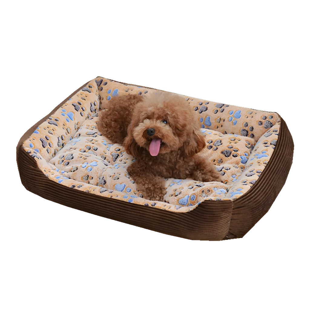 Beige plush sofa-style pet bed for small dogs with a raised bolster edge, shown in a home setting.