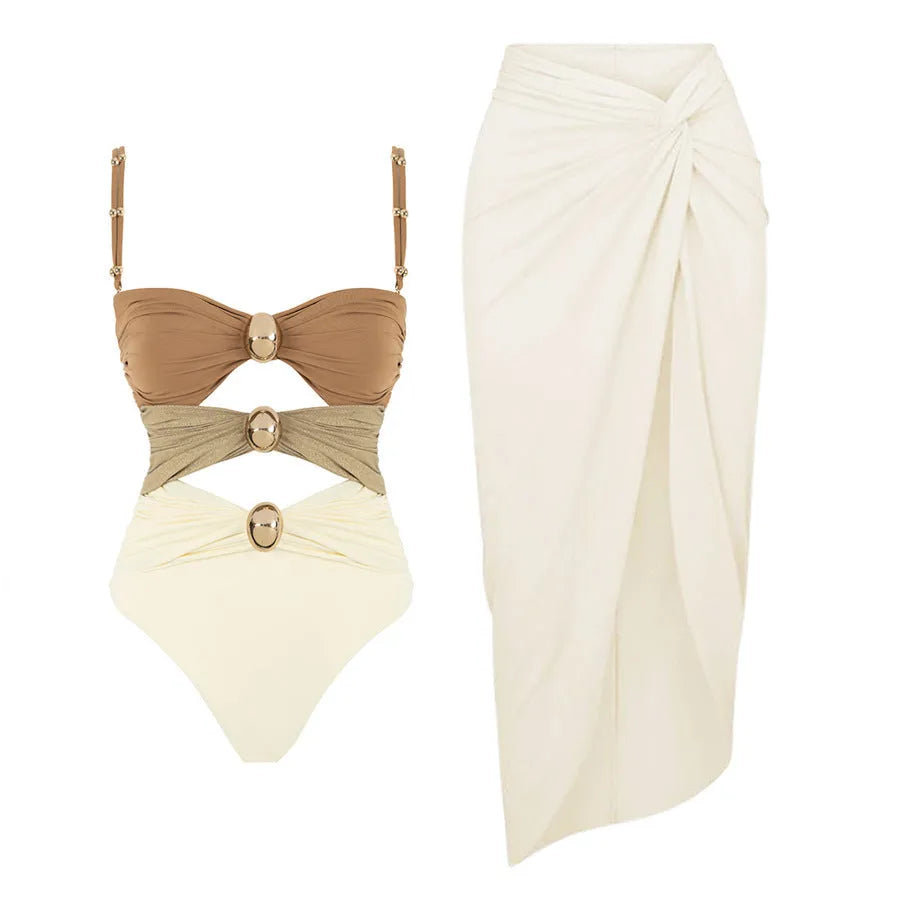 Women's solid colour one-piece swimsuit with gold button and separate matching skirt.