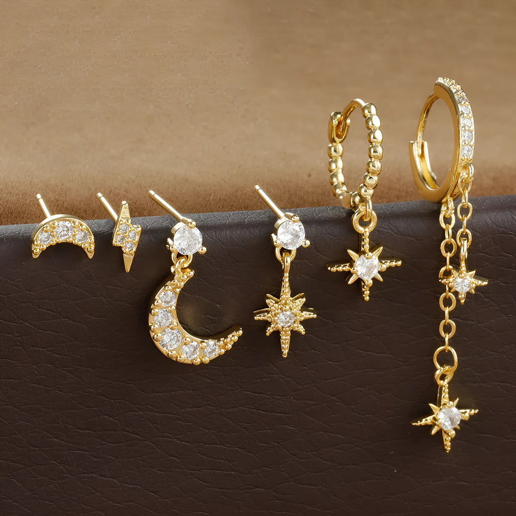 Set of six gold-coloured women's earrings with chain tassel designs and zircon studs on a white background.