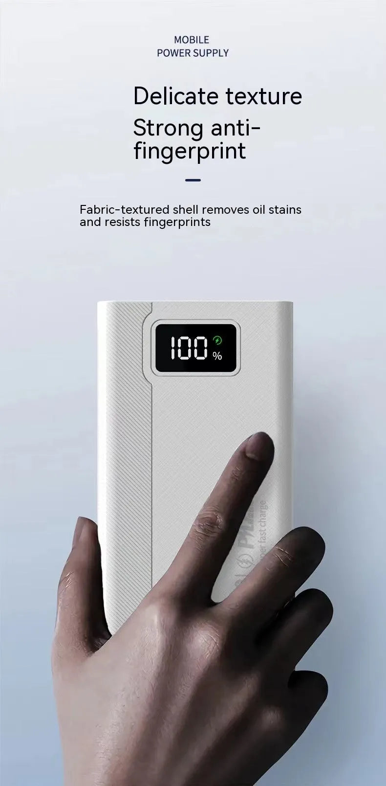 Large capacity black and white plastic power bank showing size relative to a smartphone.