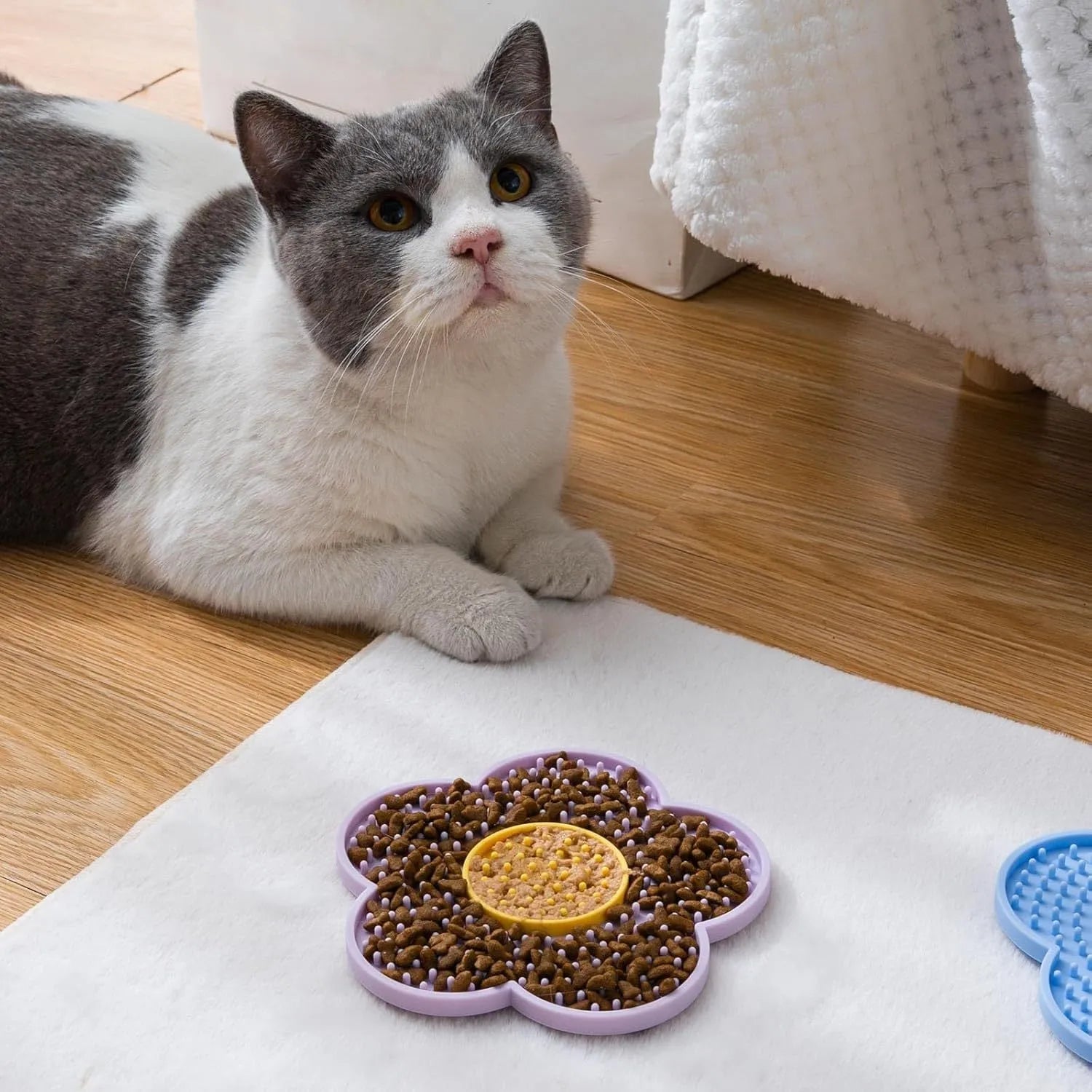 Flower-shaped silicone pet lick mat with suction cups in a choice of colours.