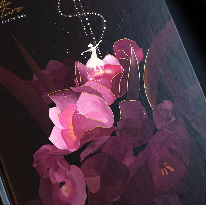 A5 notebook with a luminous cover in one of four colours, open to show pages with colour illustrations
