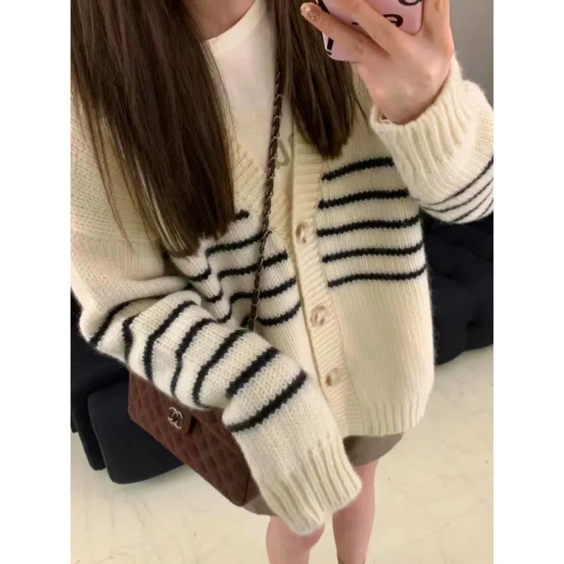 Collar button cardigan in pictured colour with 3D effect polyester fabric.