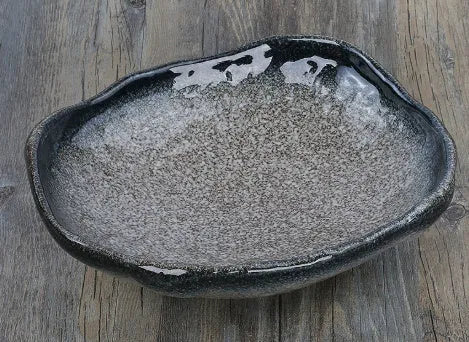 Japanese-style ceramic sashimi bowl with irregular shape and floral decoration