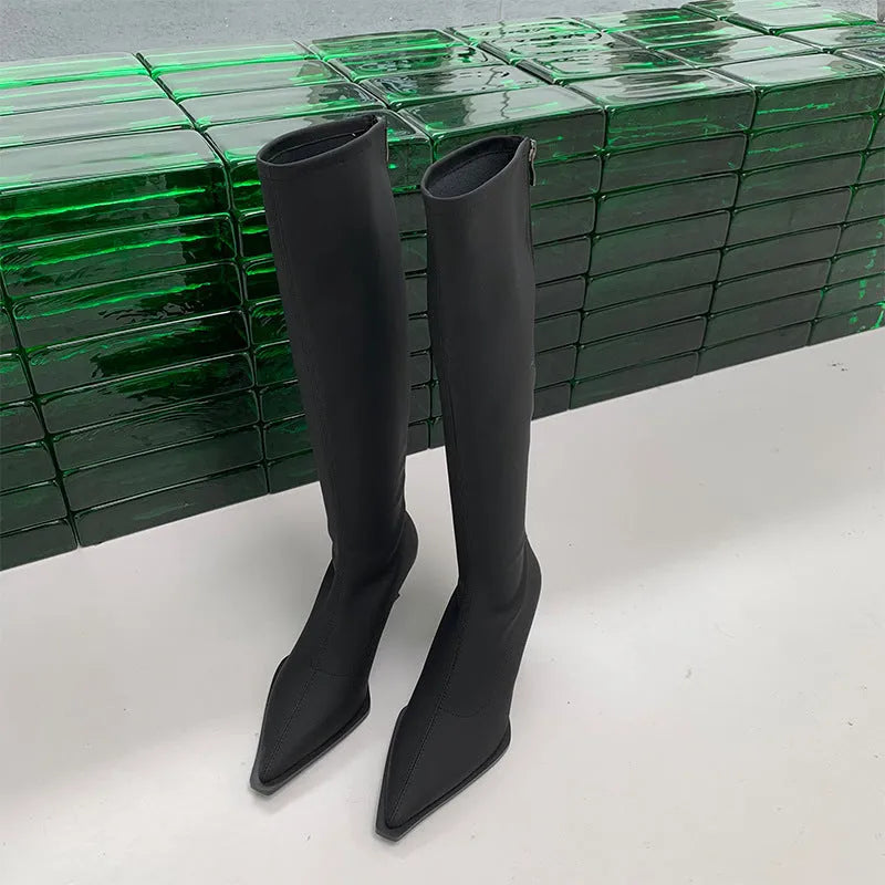 Women's black pointed toe stiletto heel boots with a back zip, shown from the side.