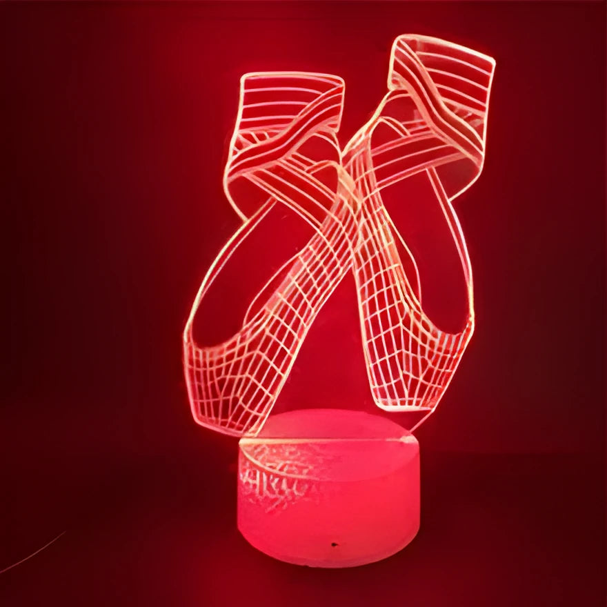 3D ballet dancer silhouette LED night light glowing in purple on a black base with remote control.