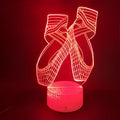 3D ballet dancer silhouette LED night light glowing in purple on a black base with remote control.