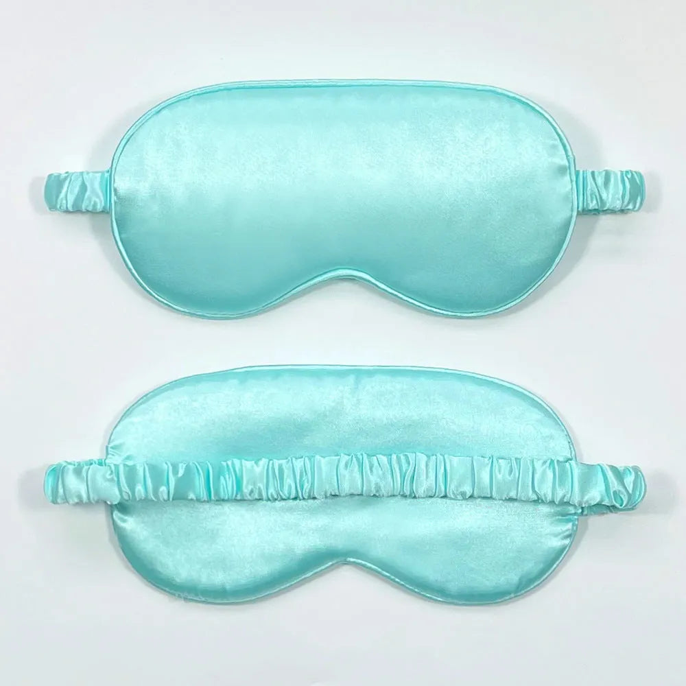 Double-sided Rayon elastic satin sleep mask shown in multiple colour options including sky blue, black, wine red, and light pink.