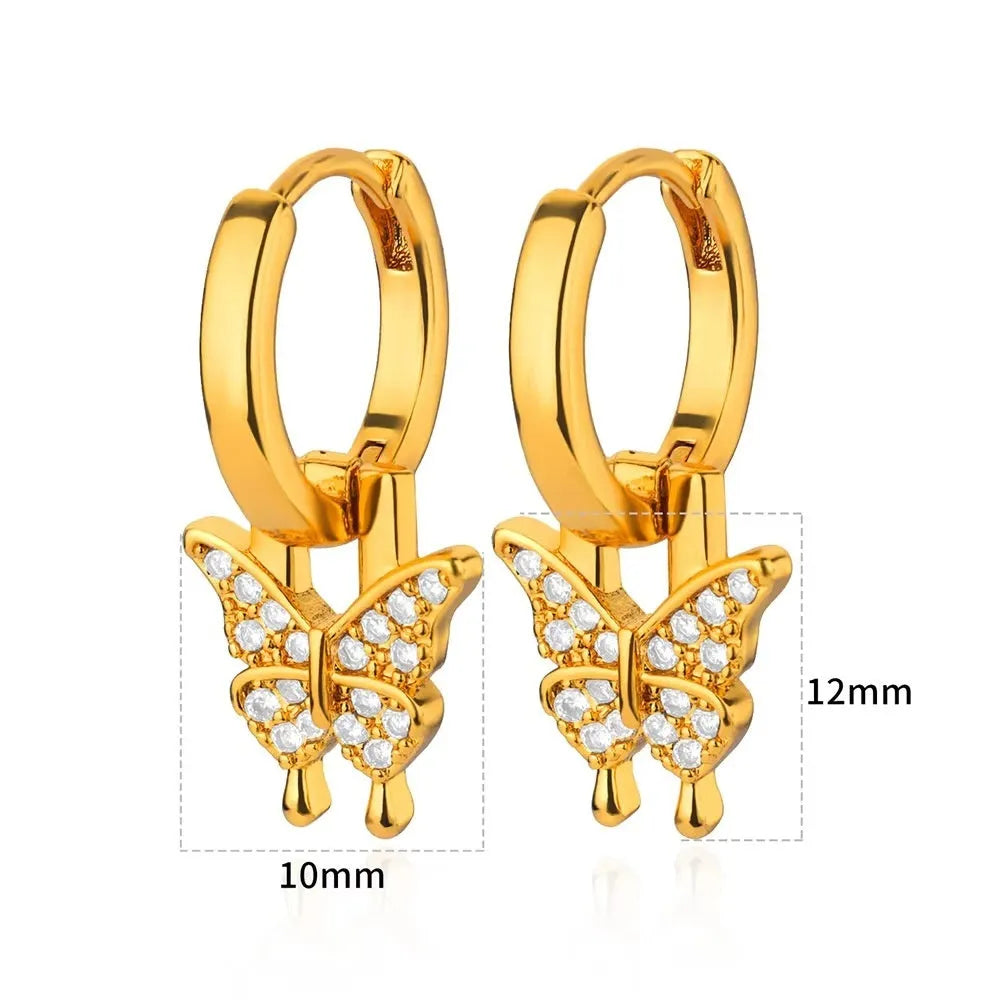 Close-up of women's geometric butterfly drop earrings with heart, star, and bow shapes in copper.