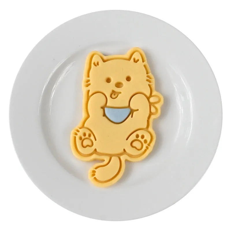 Plastic biscuit mould showing three-dimensional puppy head design with birthday hat for baking