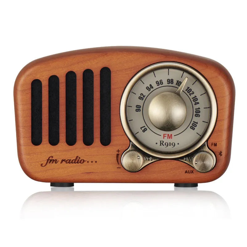Retro wooden wireless mini speaker in cherry wood finish showing front grille and compact size