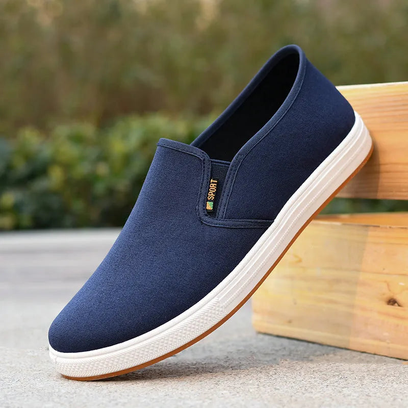 Men's black slip-on canvas shoes with round toe and composite sole