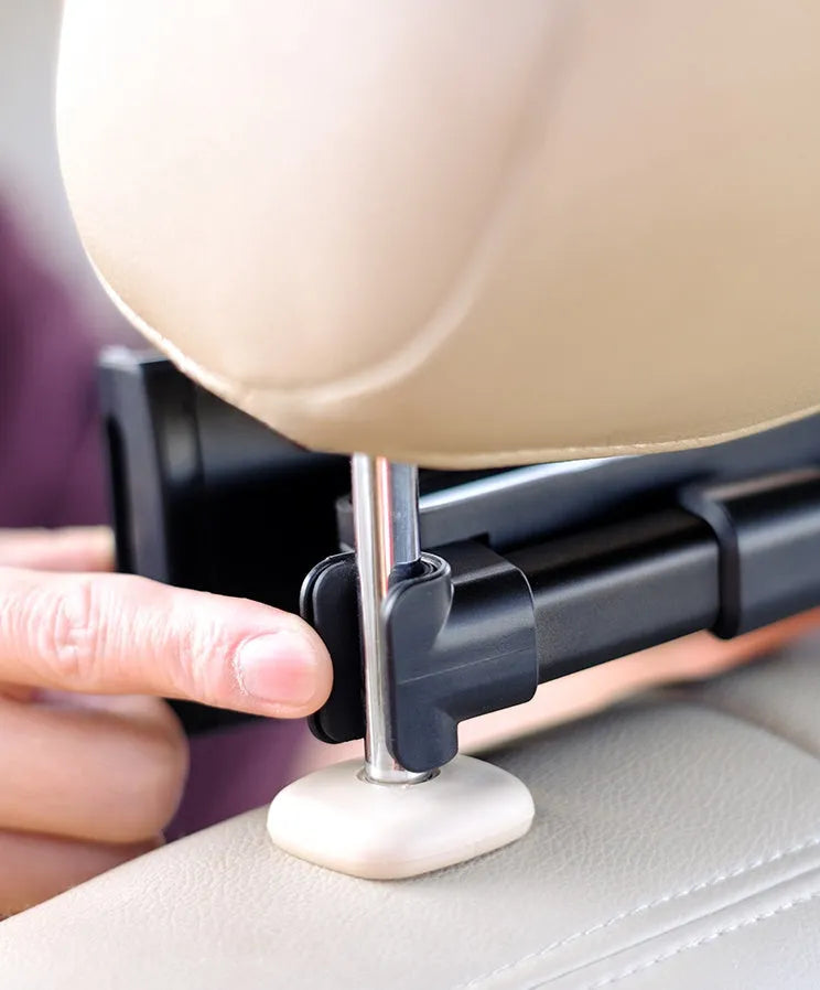 Black car phone holder mounted on vehicle rear seat base holding tablet for navigation
