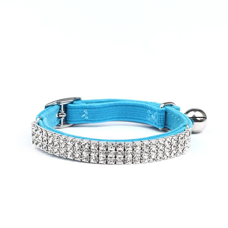 Red velvet cat collar with rhinestones, showing adjustable buckle set to 25cm length.