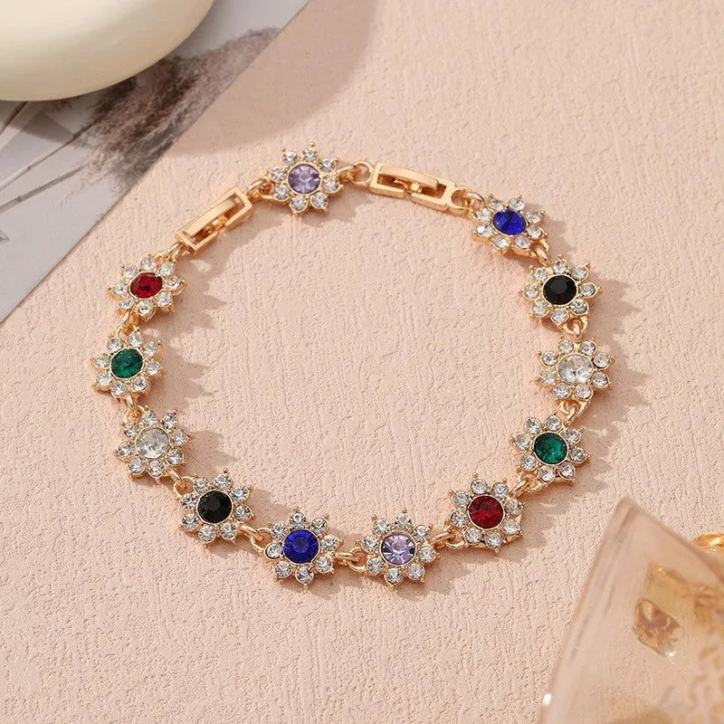 Electroplated zinc alloy flower bracelet in a choice of gold or silver finishes with coloured gemstone designs.