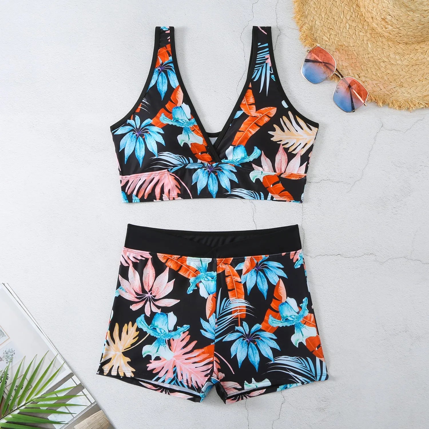 Women's two-piece swimsuit with sleeveless top and printed boxer shorts in multiple colours.