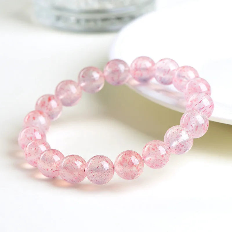 Natural white strawberry quartz ball bracelet with 10-10.8mm spherical beads.