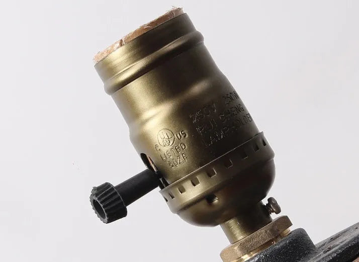Small wooden and iron water pipe shaped table lamp on a table