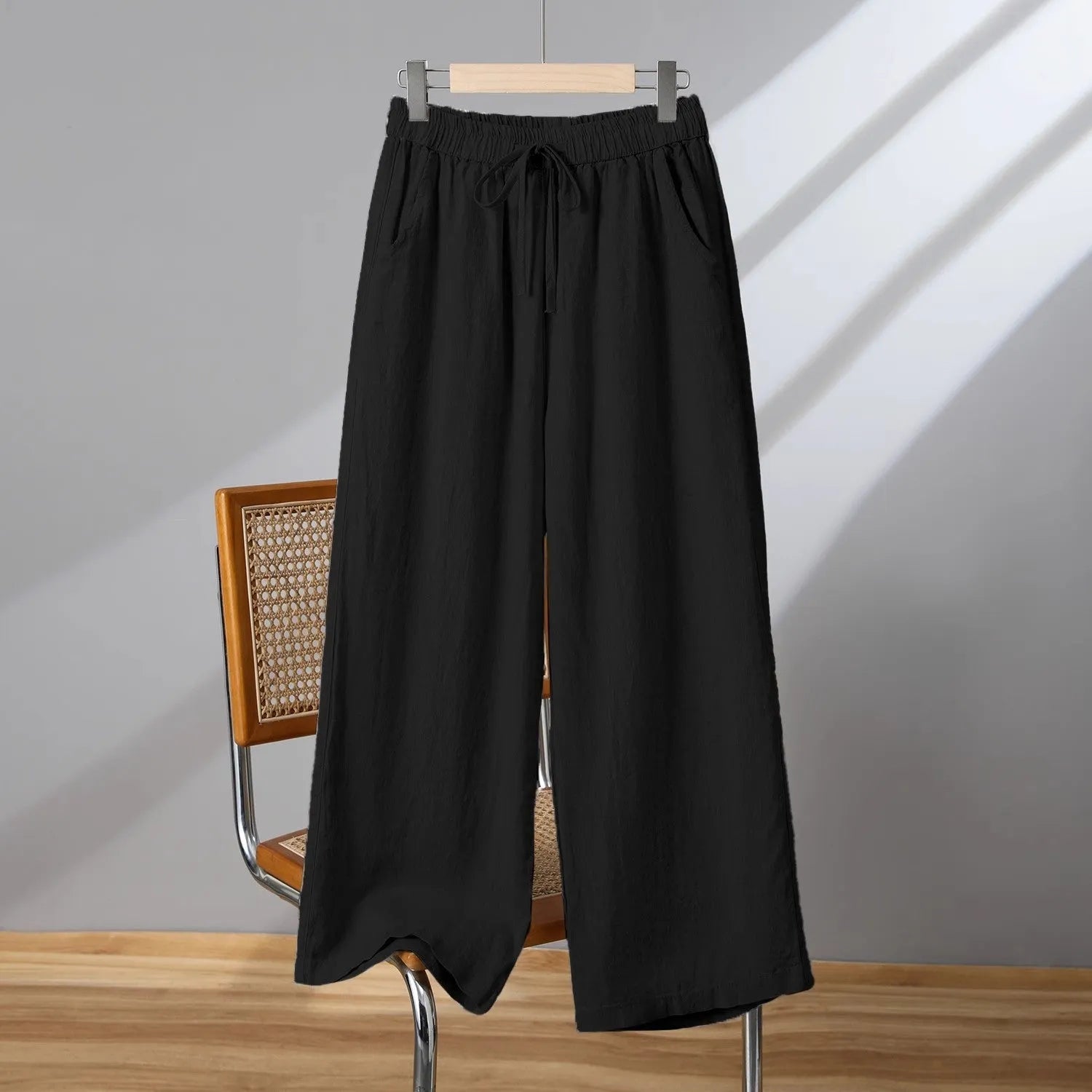 Women's straight-leg casual trousers in apricot colour with elastic and lace-up drawstring waistband.
