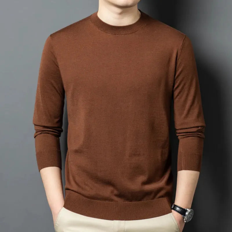 Men's round neck wool pullover sweater in a neutral colour with long sleeves, laid flat.