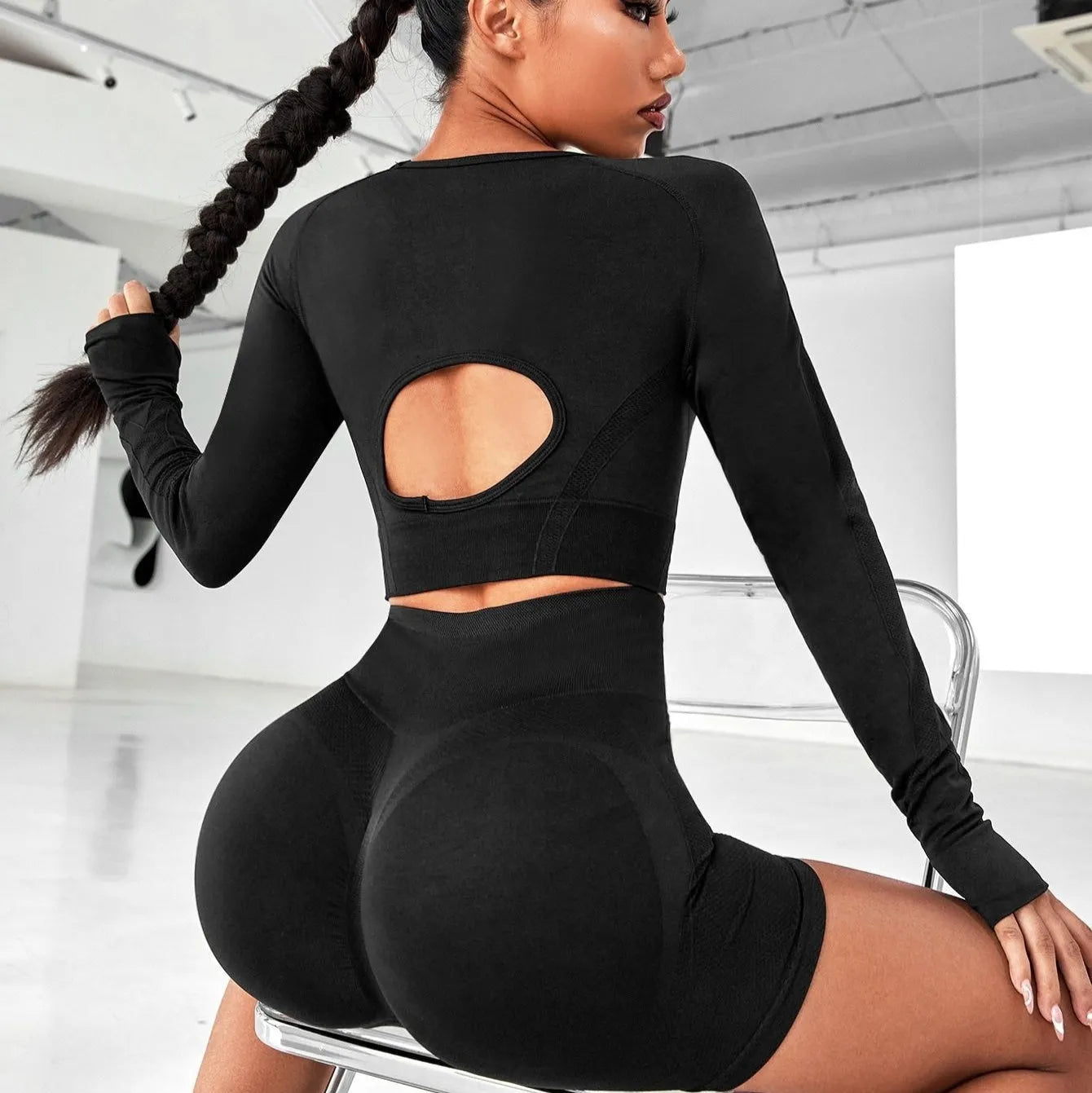 Women's black high-waisted yoga suit set with long sleeves, showing front and back view.