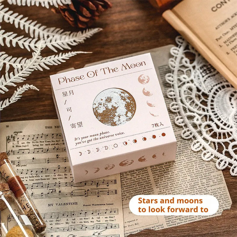 Set of seven wooden craft stamps for DIY journal decoration in stars and moon or plant catalog designs.
